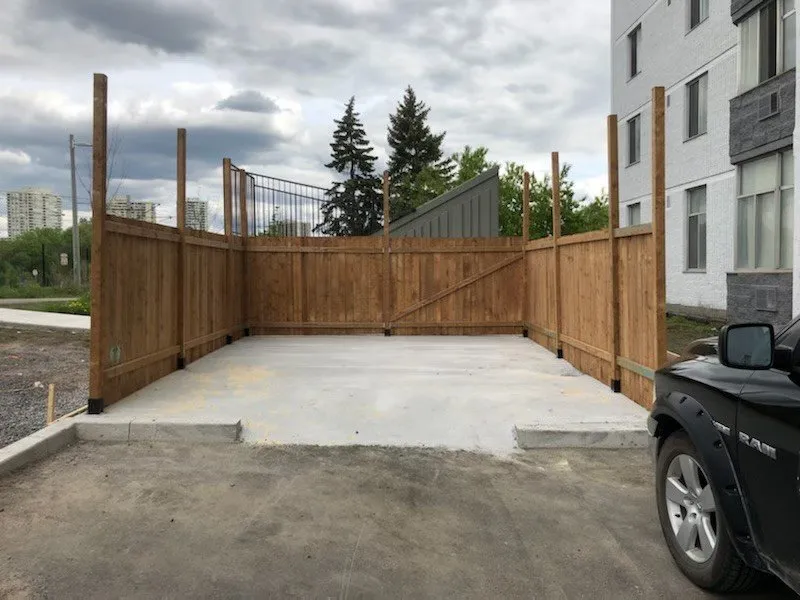 Wooden bin enclosure built by WasteMind beside an Ottawa apartment building