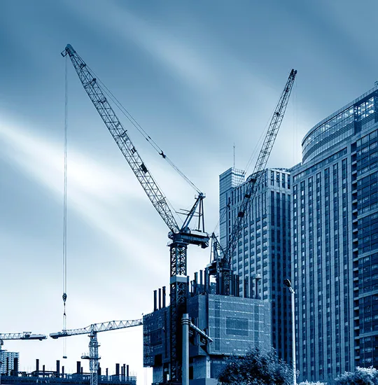 Construction cranes above a city skyline