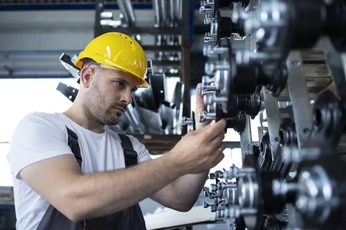 Technician performing scheduled maintenance on industrial equipment